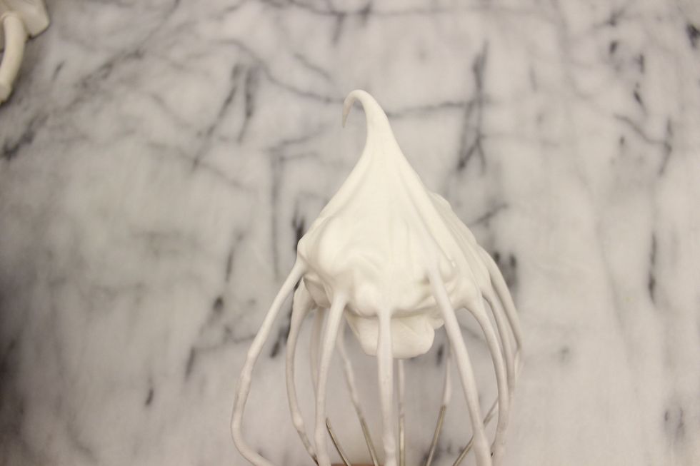 Now, back to your meringue - check the consistency. It is perfect when it can hold a stiff peak. In this picture, my peak has drooped over meaning it still needs to be beaten some more.