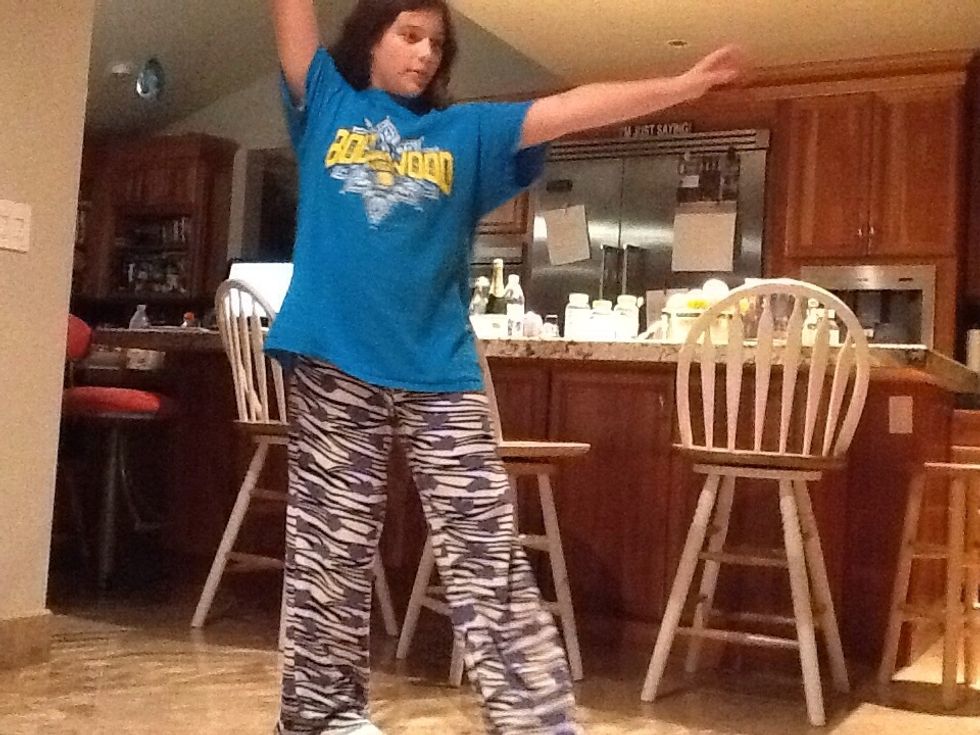 Now, bring your hand that has the ball in it, up to make the shape of a "K" with your body.