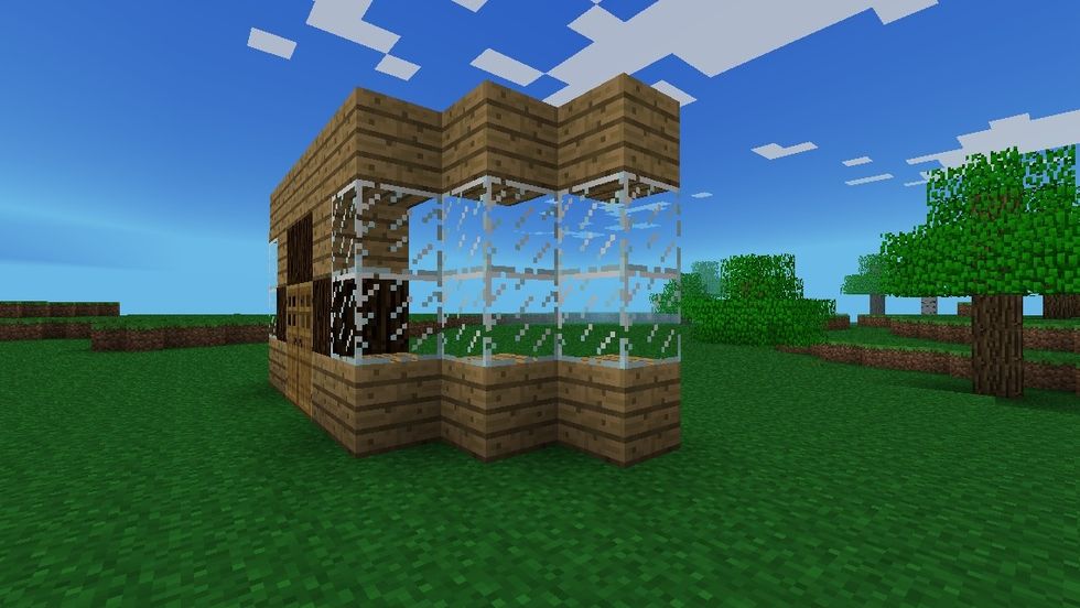 Now build 2 towers of glass and wood diagonally from the first one. Do this on both sides.