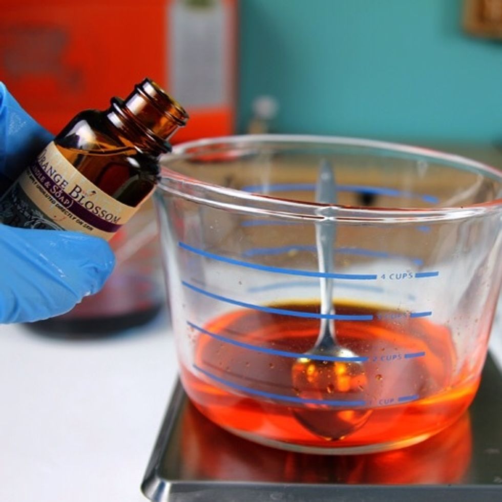Now carefully pour one container of wax per mold. I put the blue wax in the Lotus Blossom mold, the orange wax in the Citrus mold and the red wax in the Apple mold.