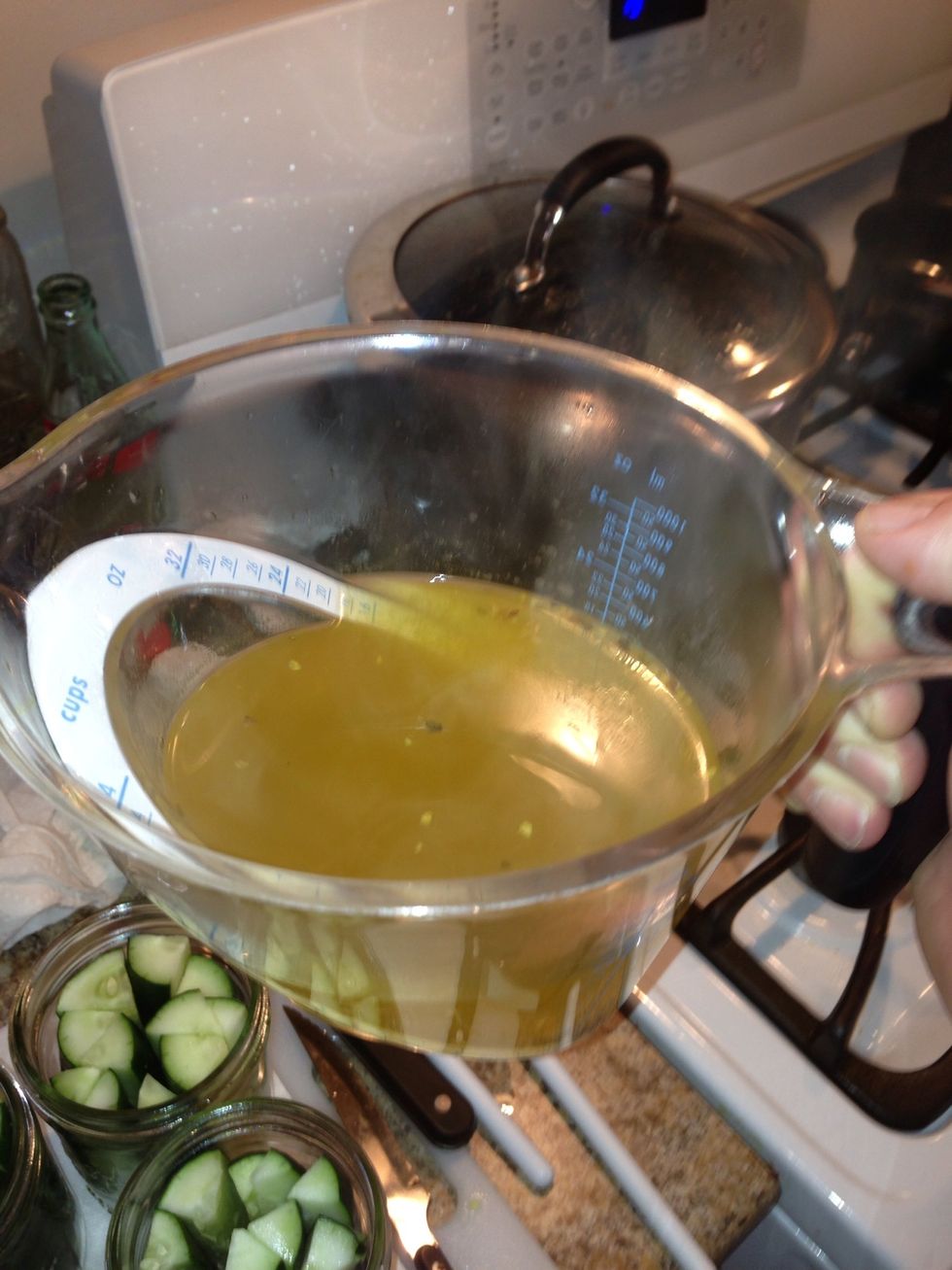 Now carefully pour your boiling dill mix into a heat safe measuring cup. Pour the liquid into the jars, try to cover the pickles but leave 1/4 inch between the lip of the jar and the juice inside.