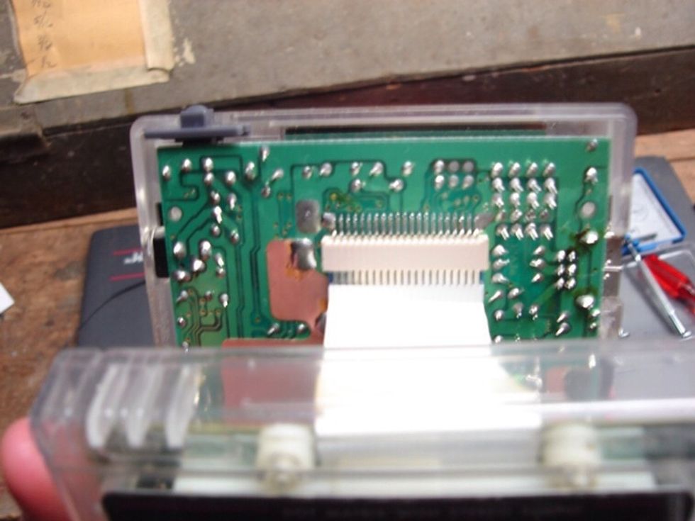 Now carefully reconnect the display cable. Put your fingers under the edge on the ribbon cable and push it up into place.