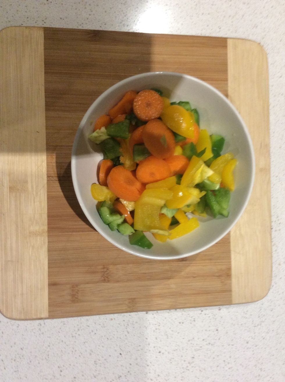 Now chop the capsicum into little pieces like shown in the image, and pop every little bit of veggie in the bowl.   Pro Tip: Cut the capsicum from the inside, it's softer and easier to cut.