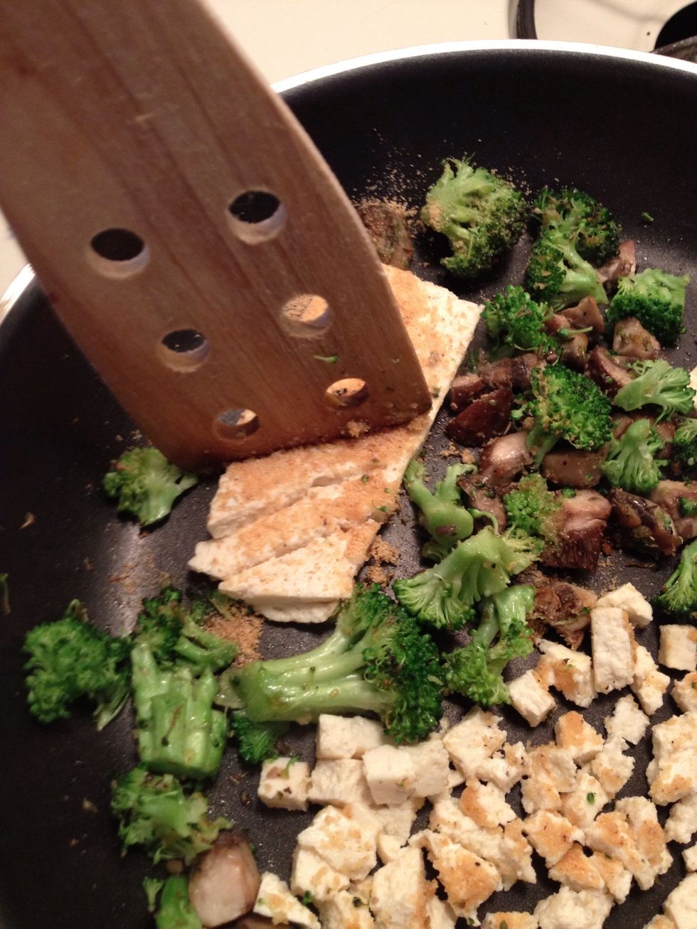 Now chop up the tofu with a spatula in chunks