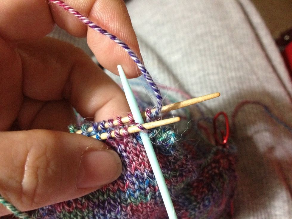 Now come back to the stitches on the front needle. The next three photos show how to do two steps at once: 1) Place the tapestry needle knitwise into the 1st stitch.