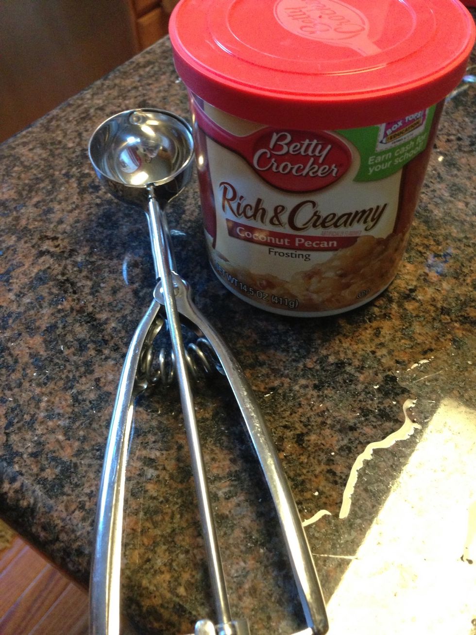 Now comes the fun! Add the frosting using the medium scoop all around the middle to the UNCOOKED CAKE! This scoop is also perfect for cookies!