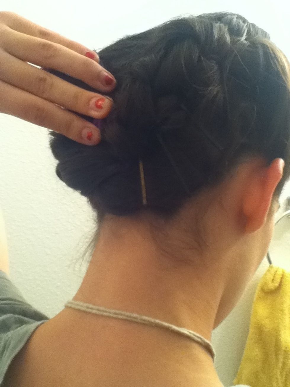 Now comes the hard part. Take the braid on the left side and take out the pony tail. Take the end and slide it over and a little under the braid on the right. I like to use big roller pins.