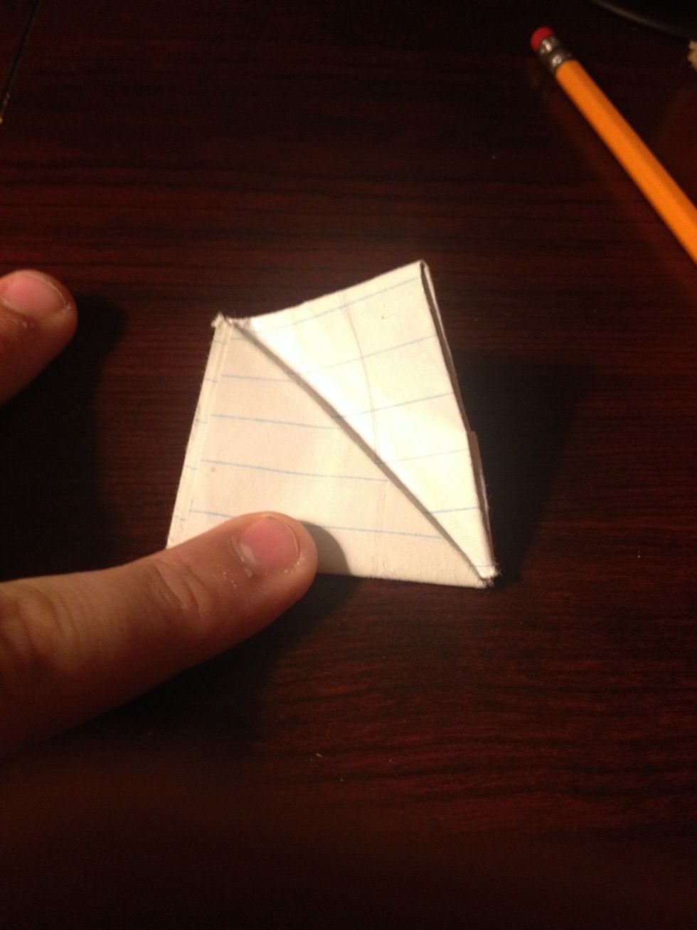 Now comes the tricky part. Slightly curve the top portion of the square to make it easier to fold