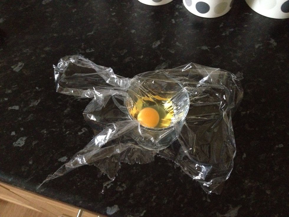 Now crack your egg into the cling film