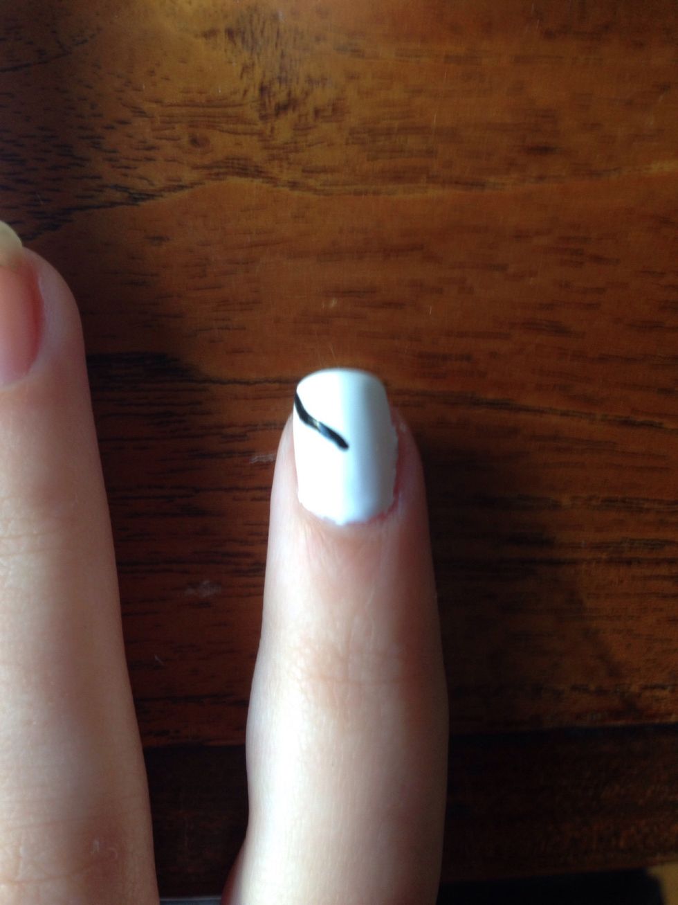 Now create a curved line using a stripping brush going to the corner of your nail