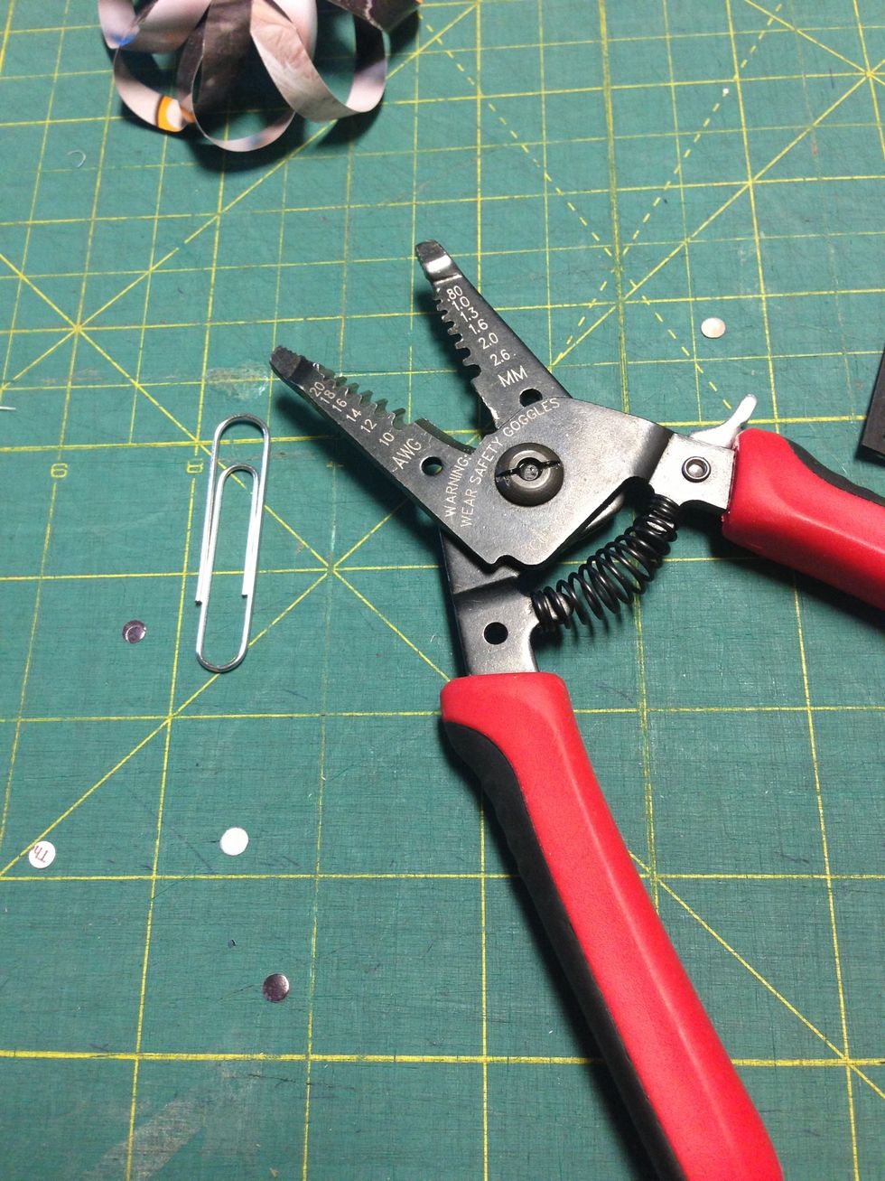 Now create the hook by straightening out a medium sized metal paper clip with pliers.