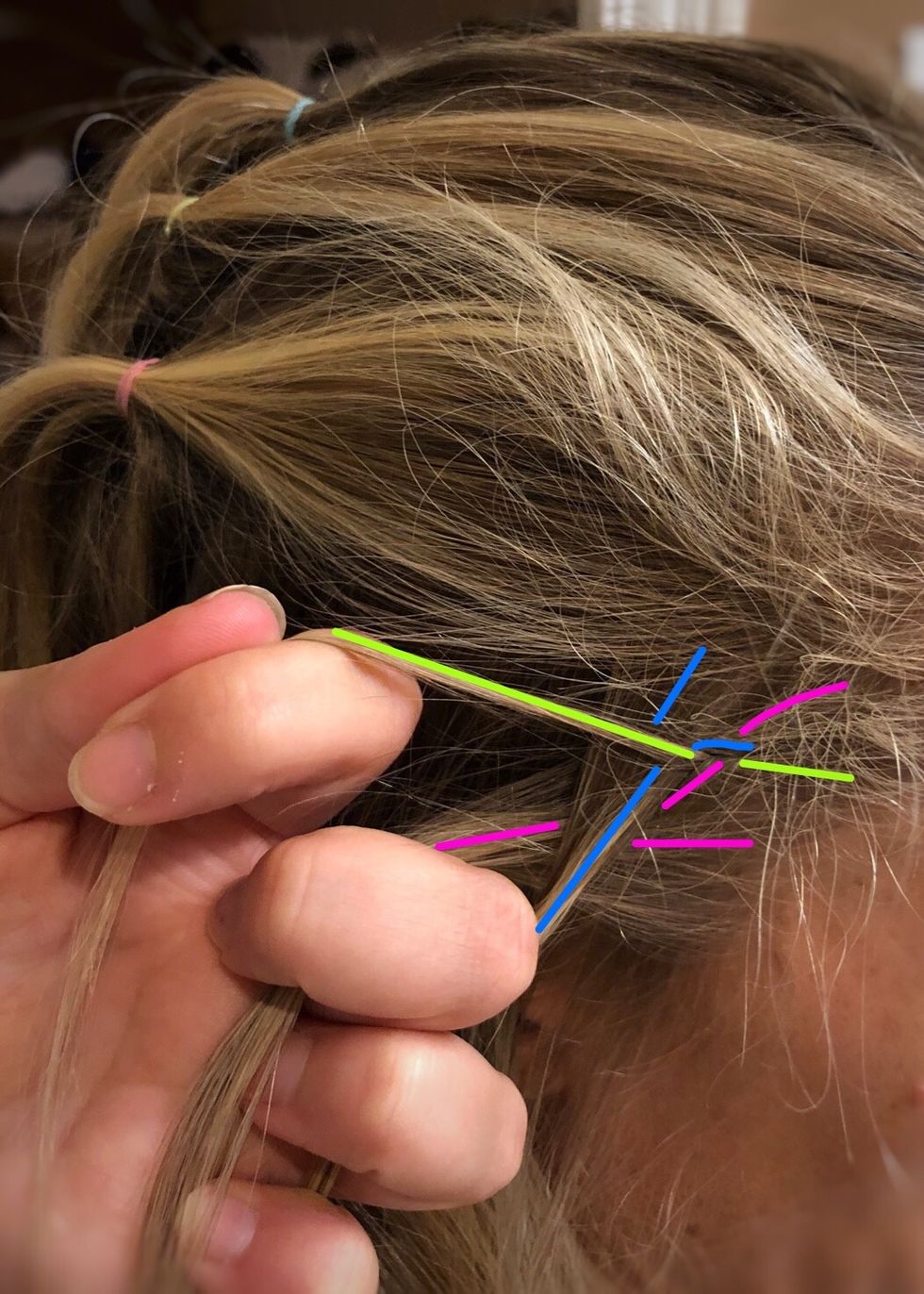 Now cross it under the blue (middle) strand.