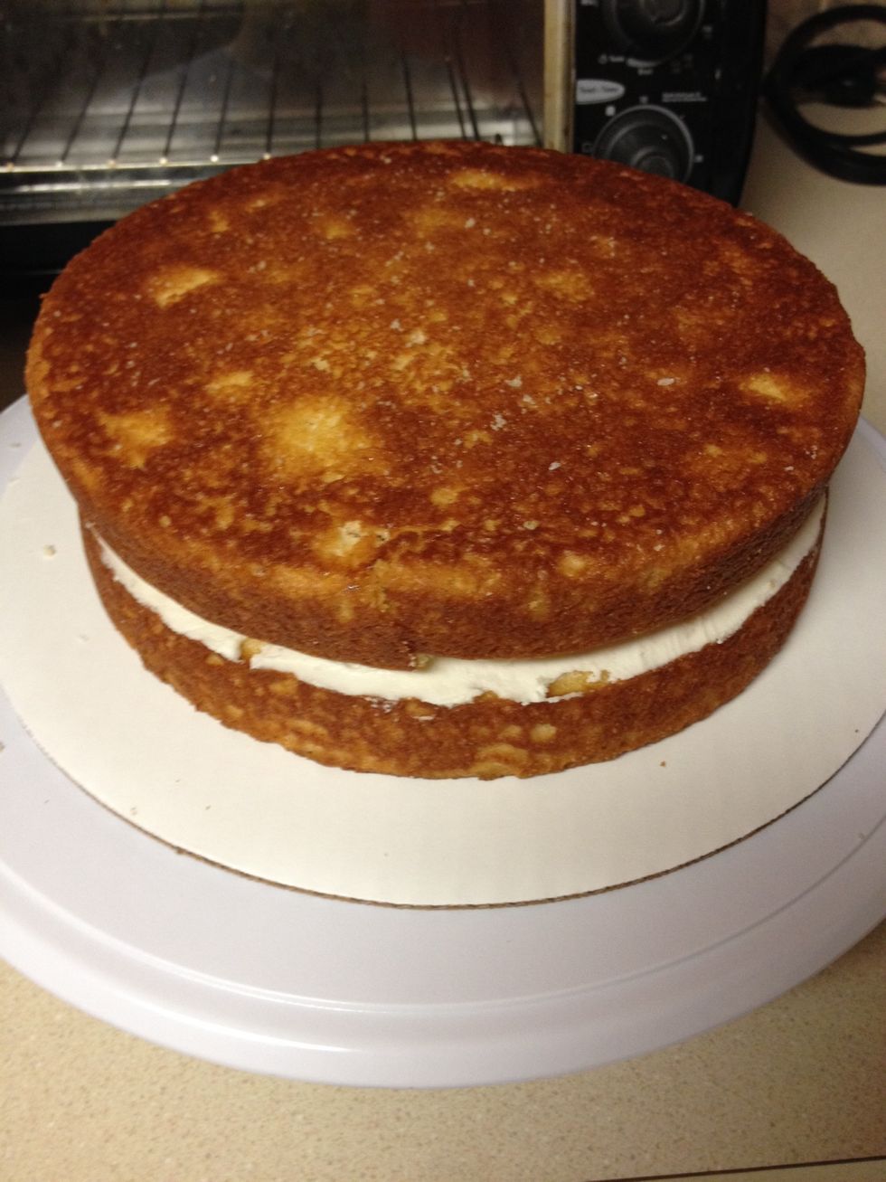 Now crumb coat the cake starting with the top and then working your way around the sides
