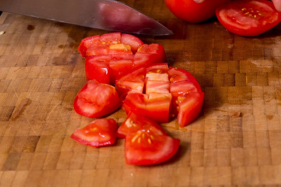 Now cube them. I usually flip them so I am always cutting into a side of the tomato and not through the skin. Even the sharpest knifes can have trouble with tomato skin .