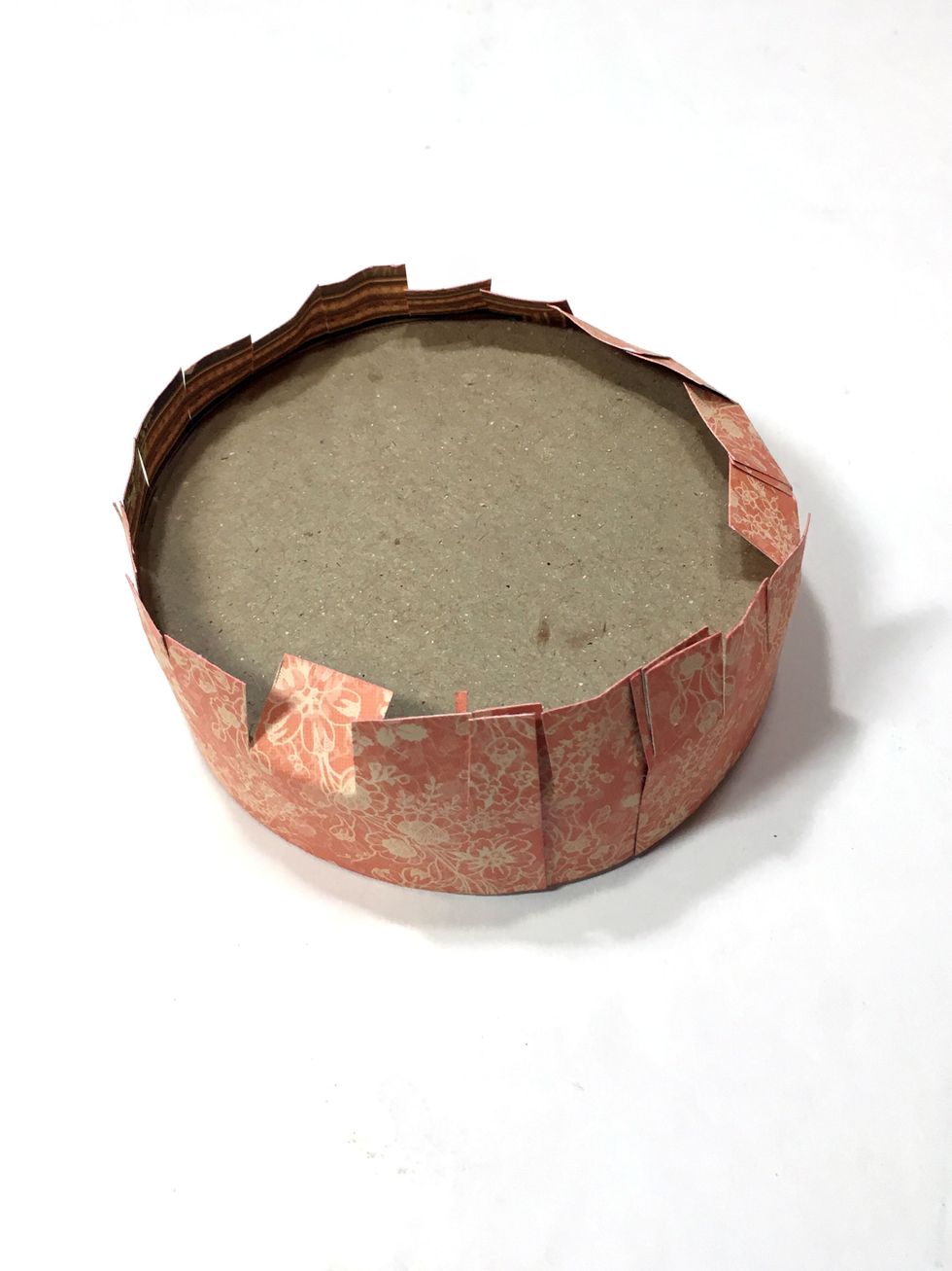 Now cut around the paper every 1/2" or so being careful to only cut to make the cuts to the top of the lid.