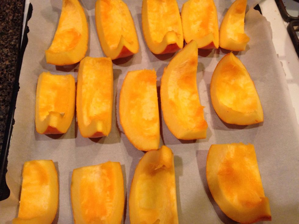 Now cut each half into pieces like these. Stick on a pan lines with parchment paper for easy cleanup. If you'd like to add a little oil here, knock yourself out. I wanted to keep it nice & pumpkin-y.