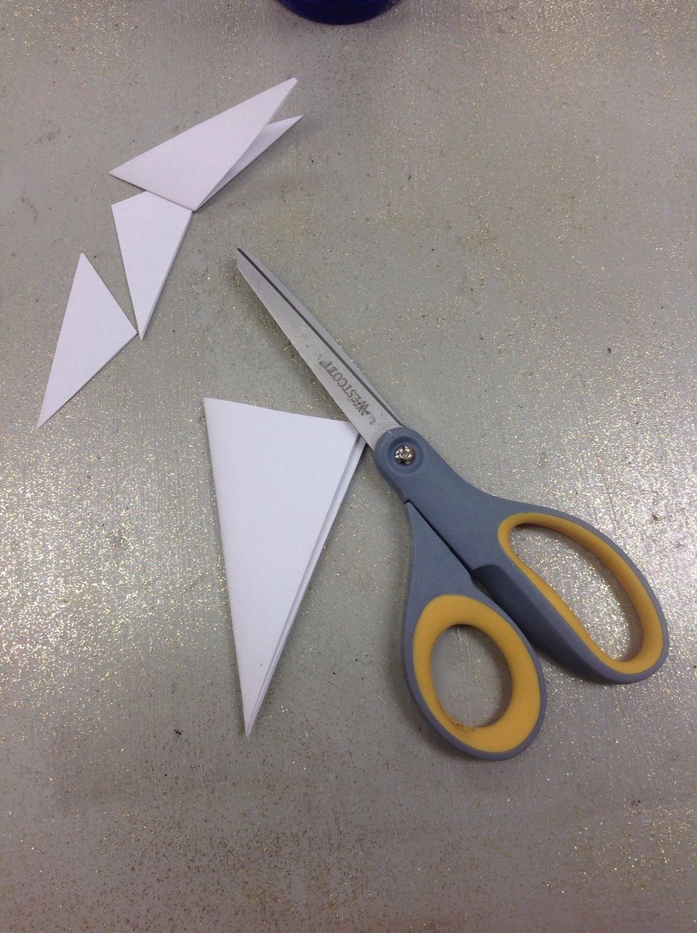 Now, cut off all of the extra paper at the top to create a smooth line at the top of the triangle.