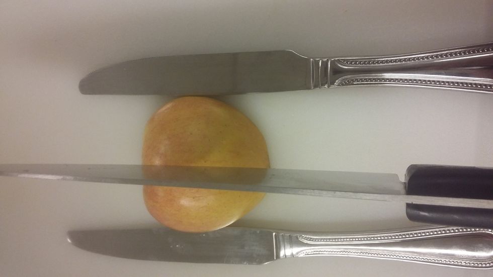 Now cut one half of the apple vertically, dont cut all the way to the bottom, leave a little space.