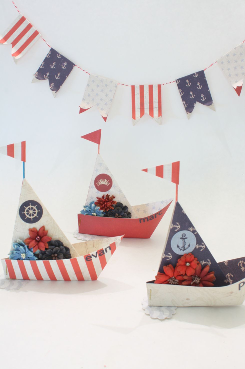 Now cut out a little banner and glue it to a toothpick, then hot glue the pick inside of the sail. I also made a cute little banner from my scraps :)