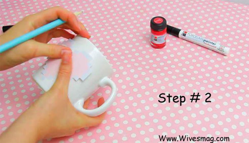 Now cut out printed image. Outline the shape on your mug using the cut stencil. If you are enough drawing expert can make a shape on mug yourself. Or you can also use free hand image.