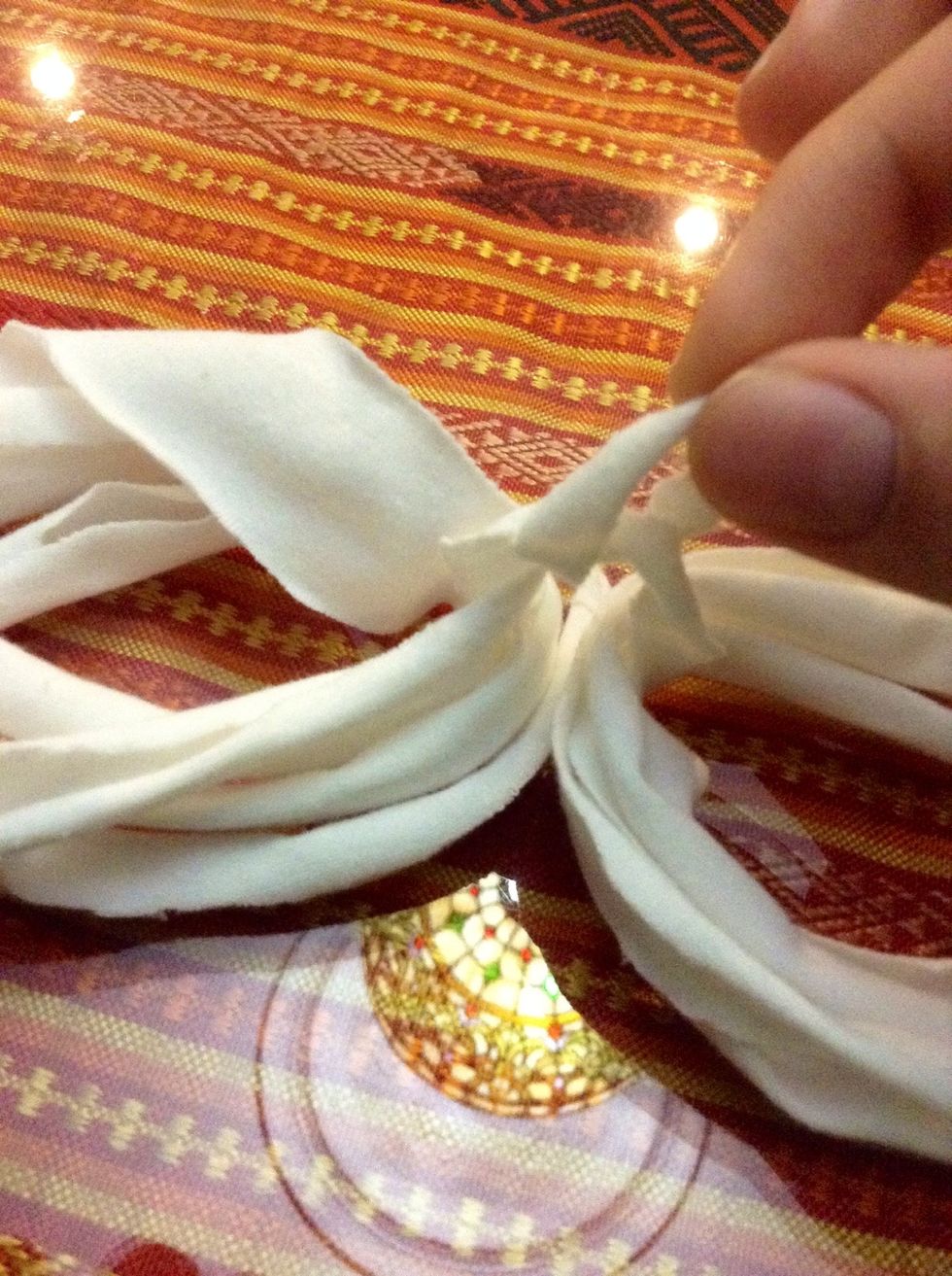 Now cut out small strings of fabric and tie two rings together.