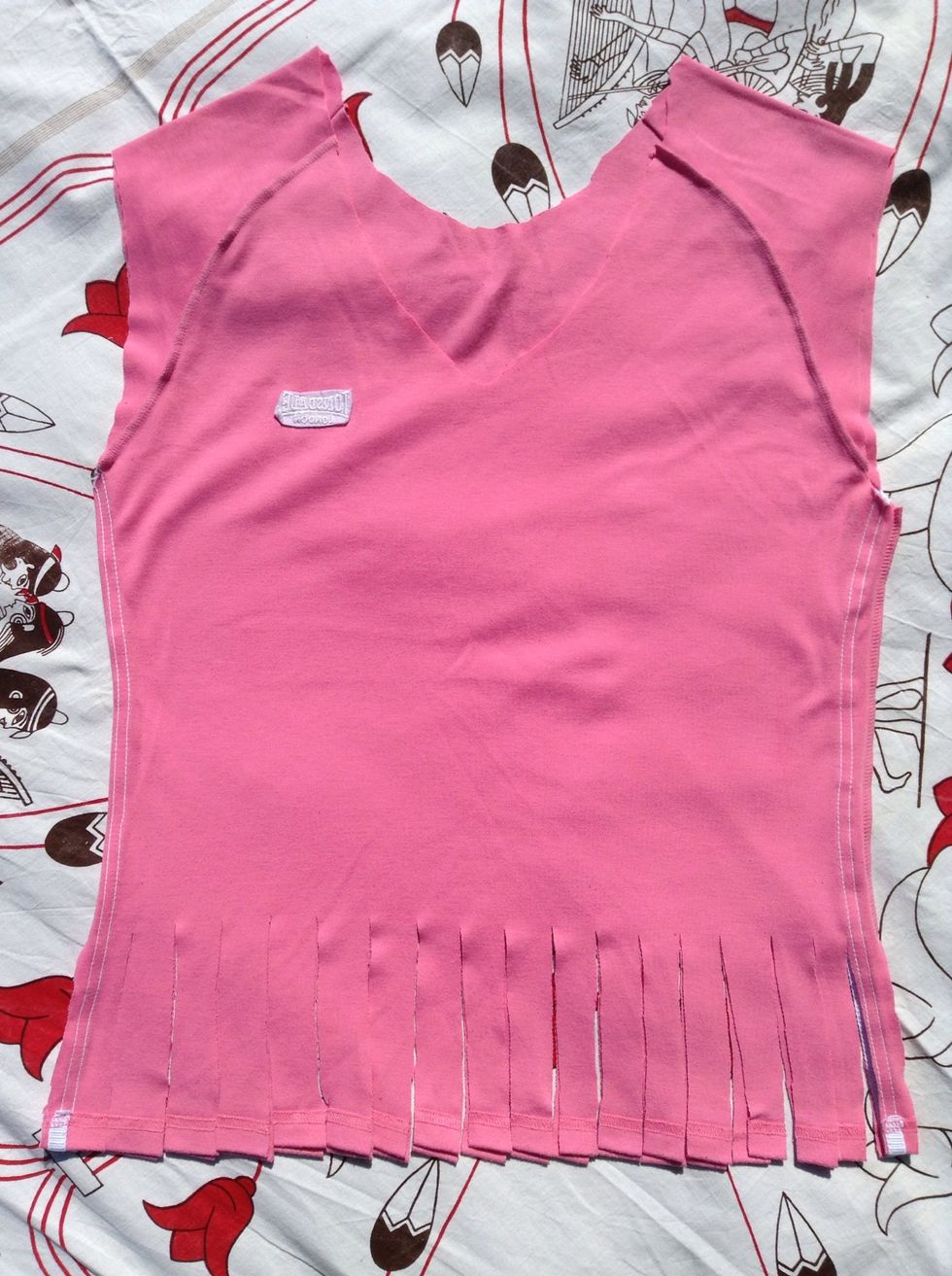 Now cut slits through both sides of the shirt about an inch in width all the way across. The pieces should be long enough for you to tie 2 or 3 knots with it.