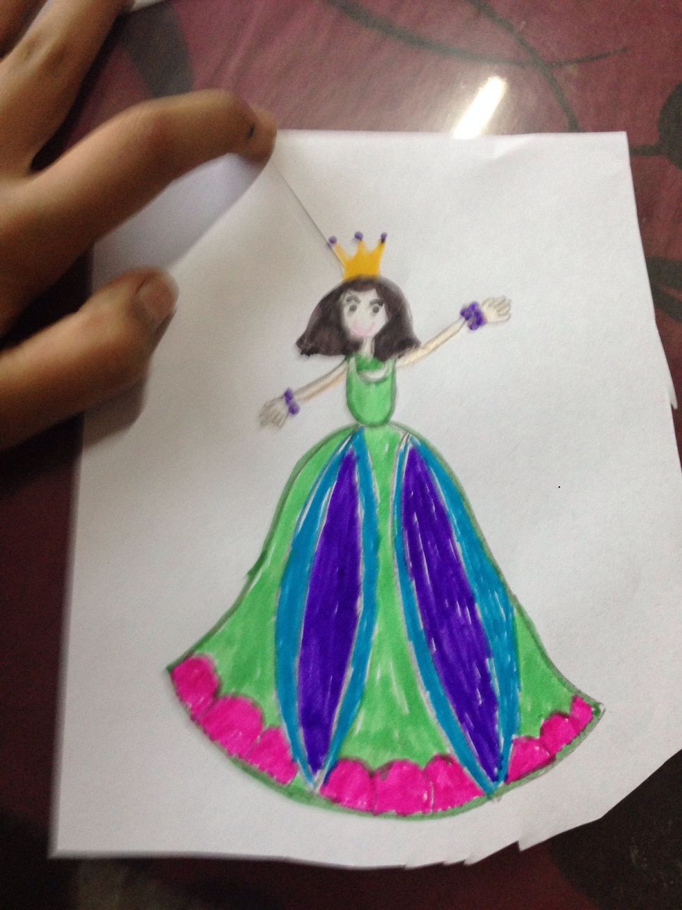 Now cut the paper into half and make sure that princess or prince is there ( like the one shown in the picture ) and now cut it very carefully