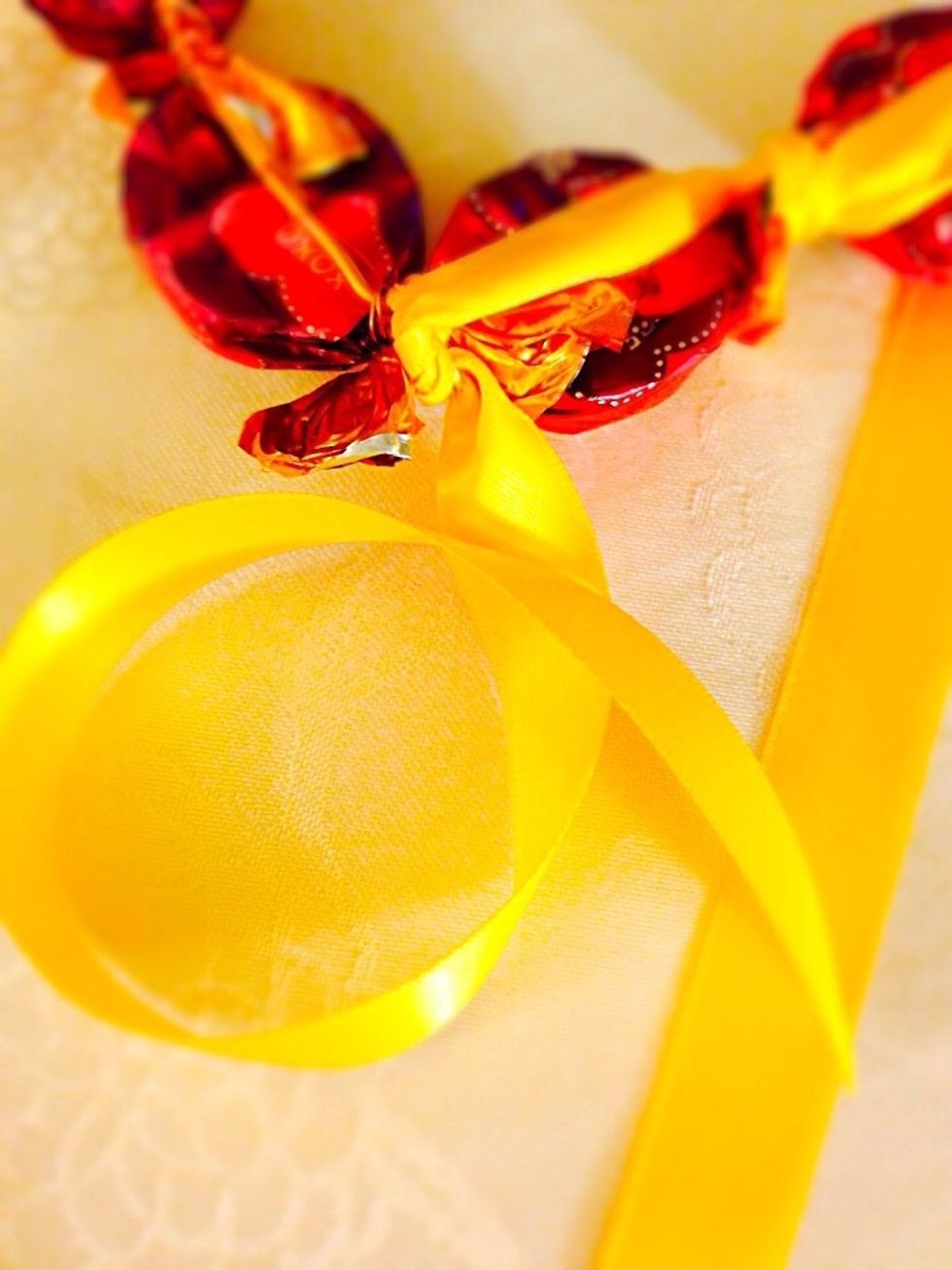 Now cut the ribbon in two leaving enough for each side of the wreath. Tie it to the bottom of the heart