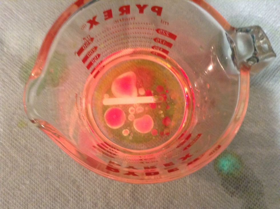 Now cut the tip off of the other glow stick and pour it into the cup.