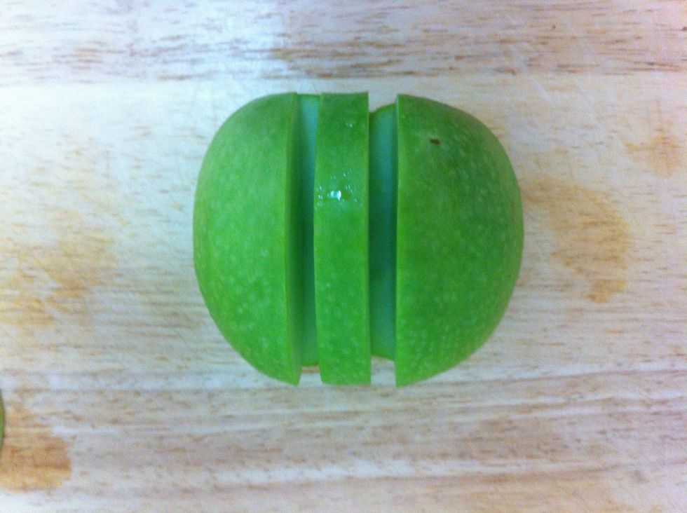 now cut two cuts from the top and two from the sides to the middle of the apple where they should meet ( leave a room between the cuts )