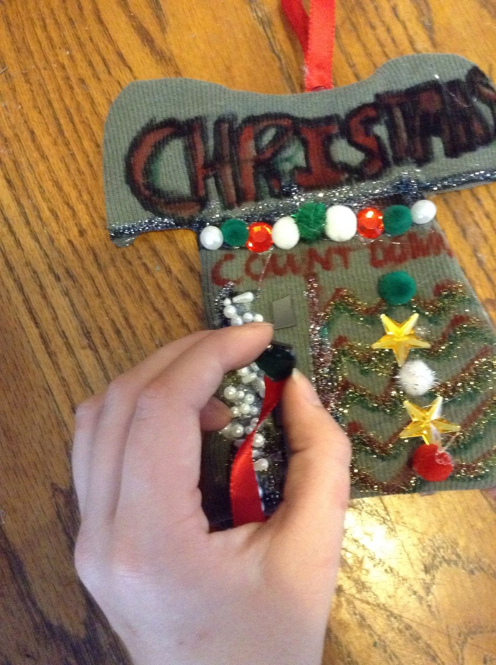 Now decorate! I used beads to write the numbers so it might be hard to read!! Anyway, I got a Christmas heart rhinestone and used magnet tape and glued it on ribbon to make the "mark"