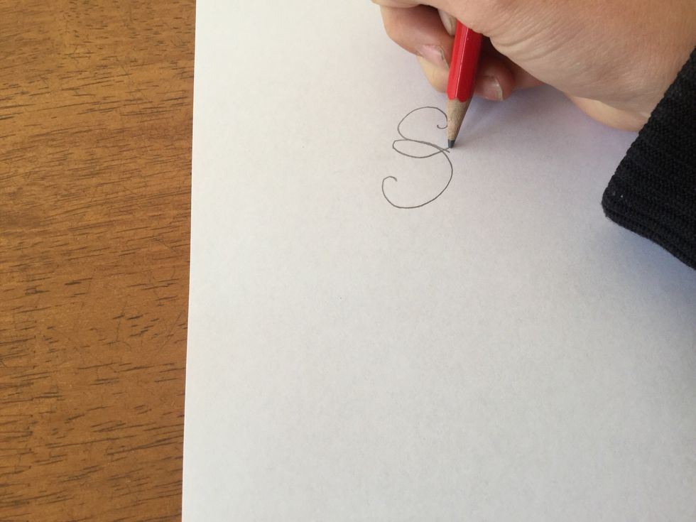 Now decorate with a loop starting in the middle of your "S" meeting the ends together in a cross