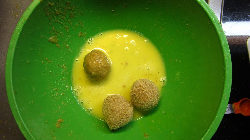 Now dip the cutlets again into the batter again. We are going to add a second coat of bread crumbs so the outer shell is stronger and not too fragile. Double bread crumbing makes it easier to fry too.