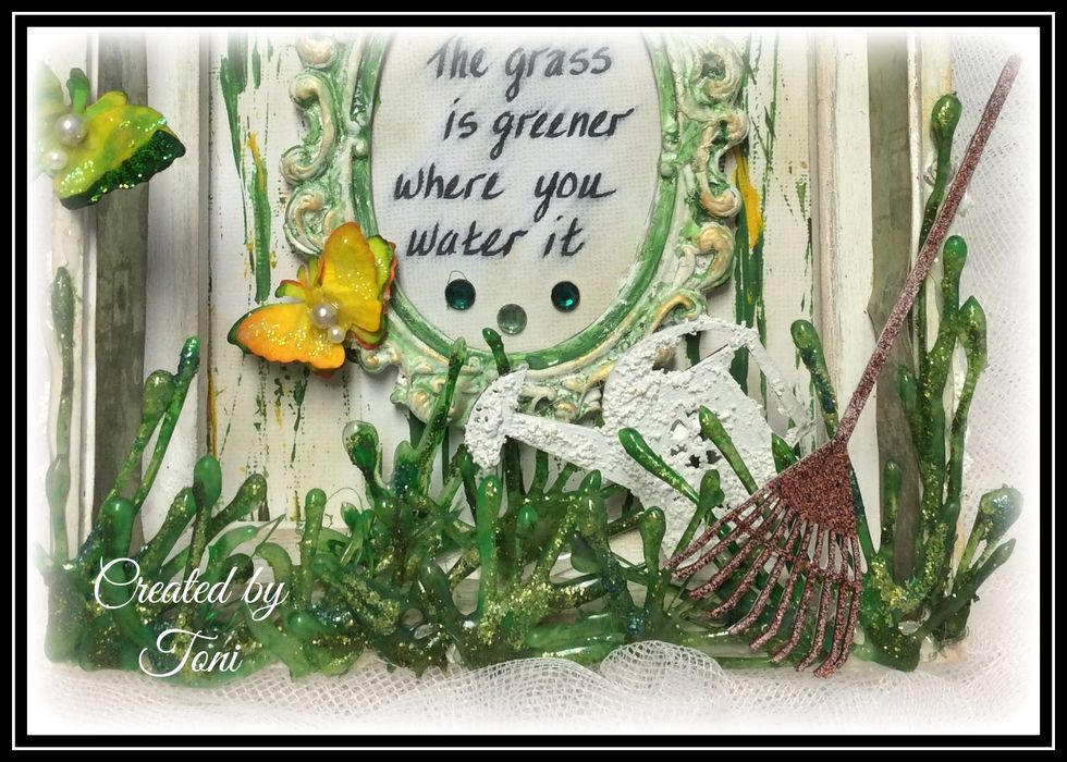 Now doesn't that grass look great... Never would have thought it to be glue... The chipboard pieces are Blue Fern. Copper embossing powder used on rake and stucco paste used on watering can.