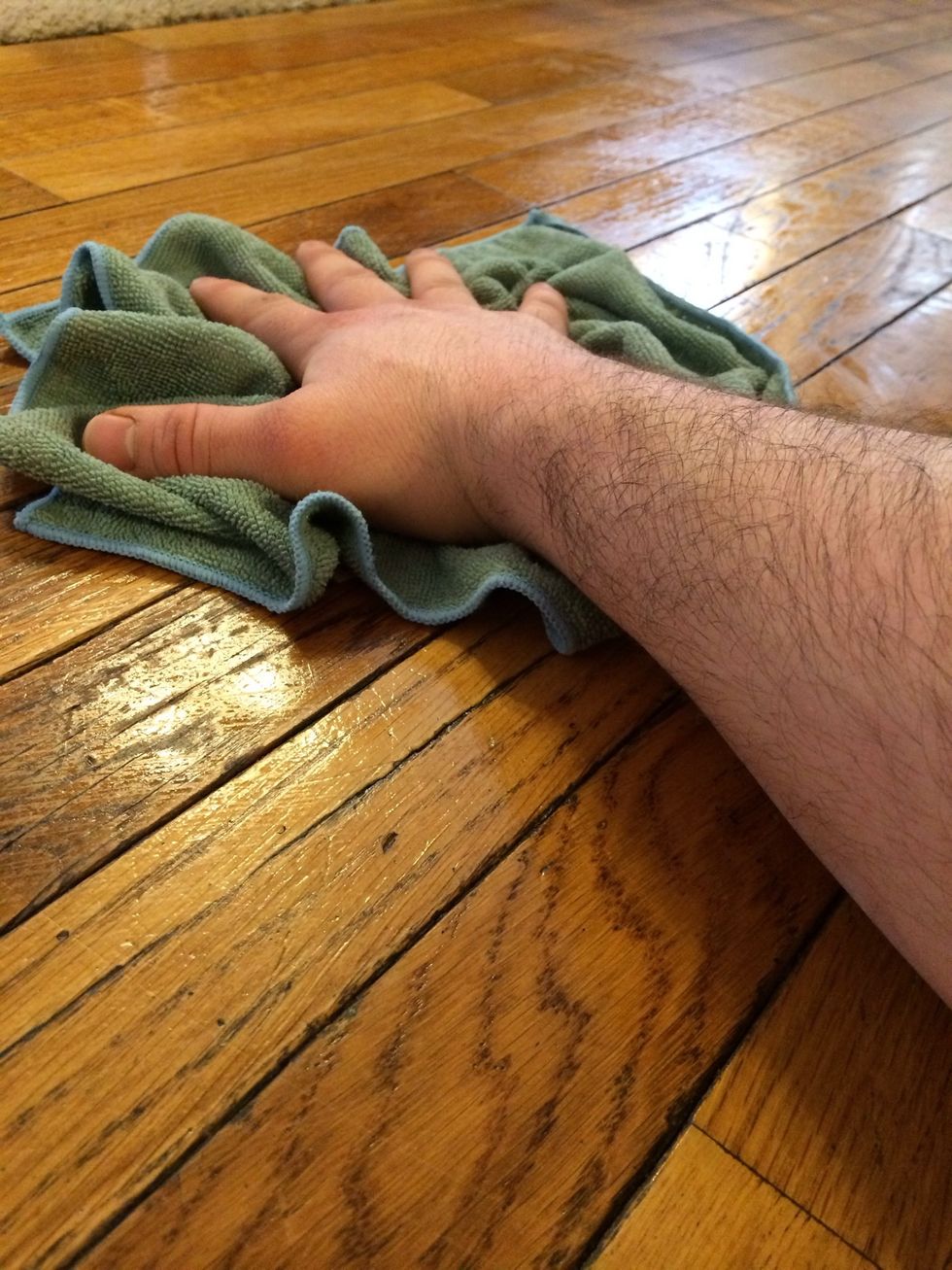 Now don't be afraid to get on your hands and knees and put some old fashioned elbow grease behind it. I clean the wood with the direction of grain. Long and wide swipes with the cloth.