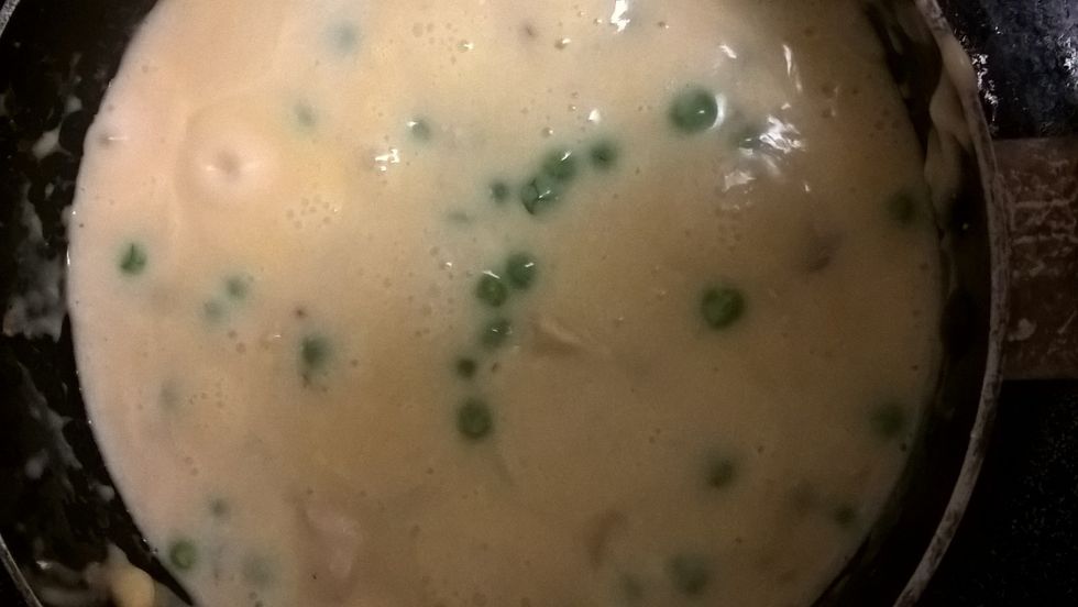 Now drain off the chicken and now stir in the peas , soup , and milk then bring to a boil