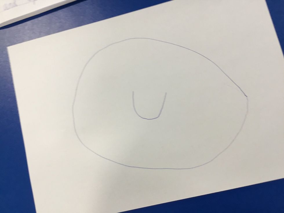 Now draw a smile in the middle of the oval