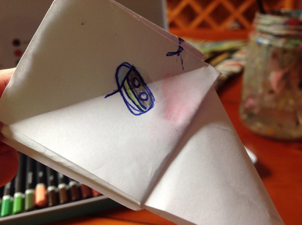 Now draw an eye, nose and colour them in. Add water to this too.