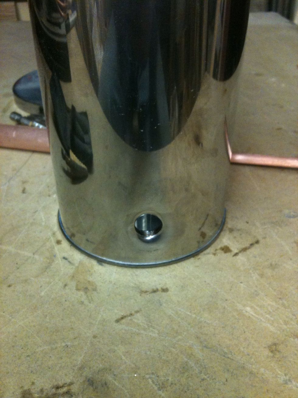 Now drill a hole near the bottom of the canister. The size needed for this hole depends in how much room you need to light the wood. I made mine about 1/2".