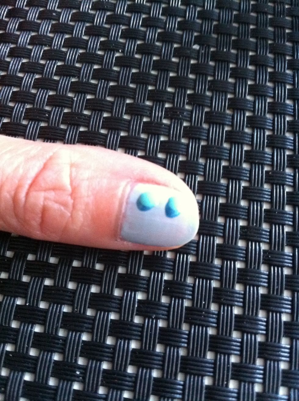 Now drop 2 little blobs of the light blue colour on the dark blue blobs. Like this \ue237.