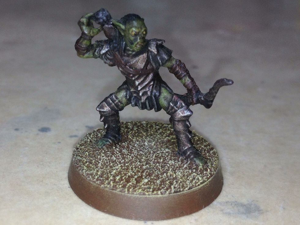 Now drybrush Karak Stone onto the sand of the base. You're almost done.