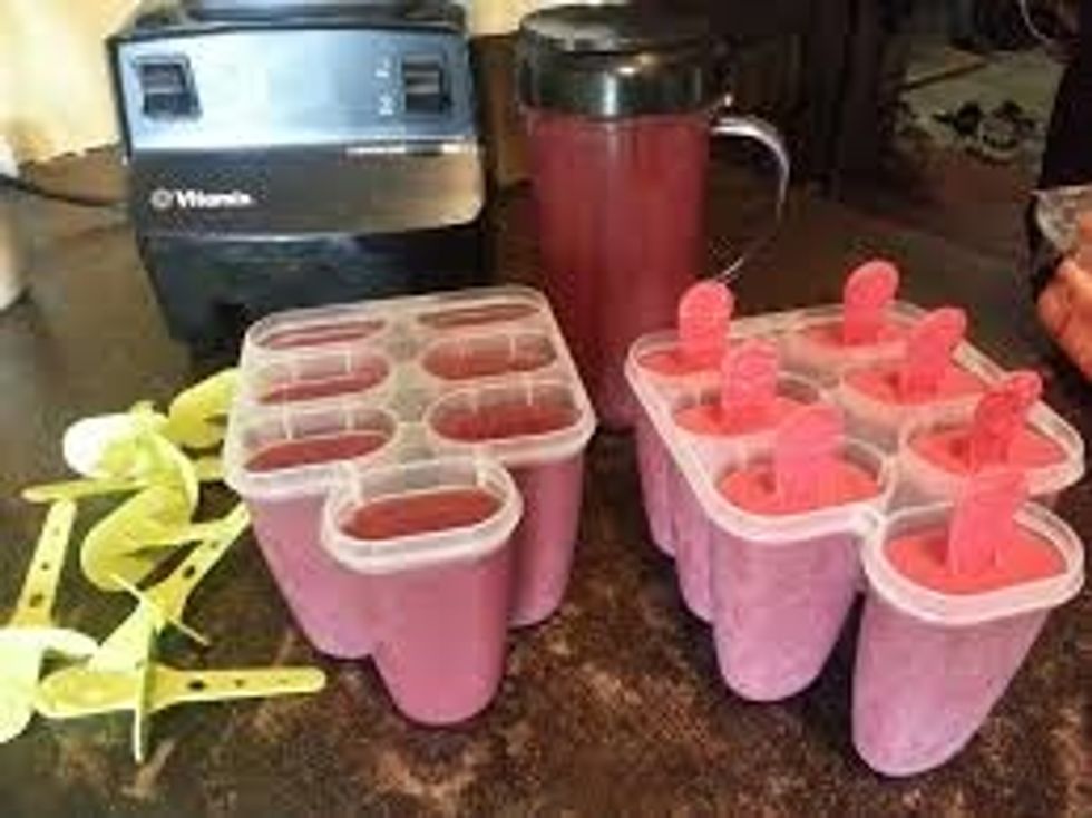 now fill your popsicle mold with the smoothie *you can also chop little pieces of the leftover fruit to see the fruit when frozen*