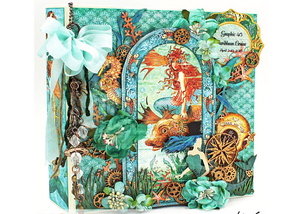 Now finish up by added flowers however you like. Tuck in some heat embossed gears here and there over the front cover.