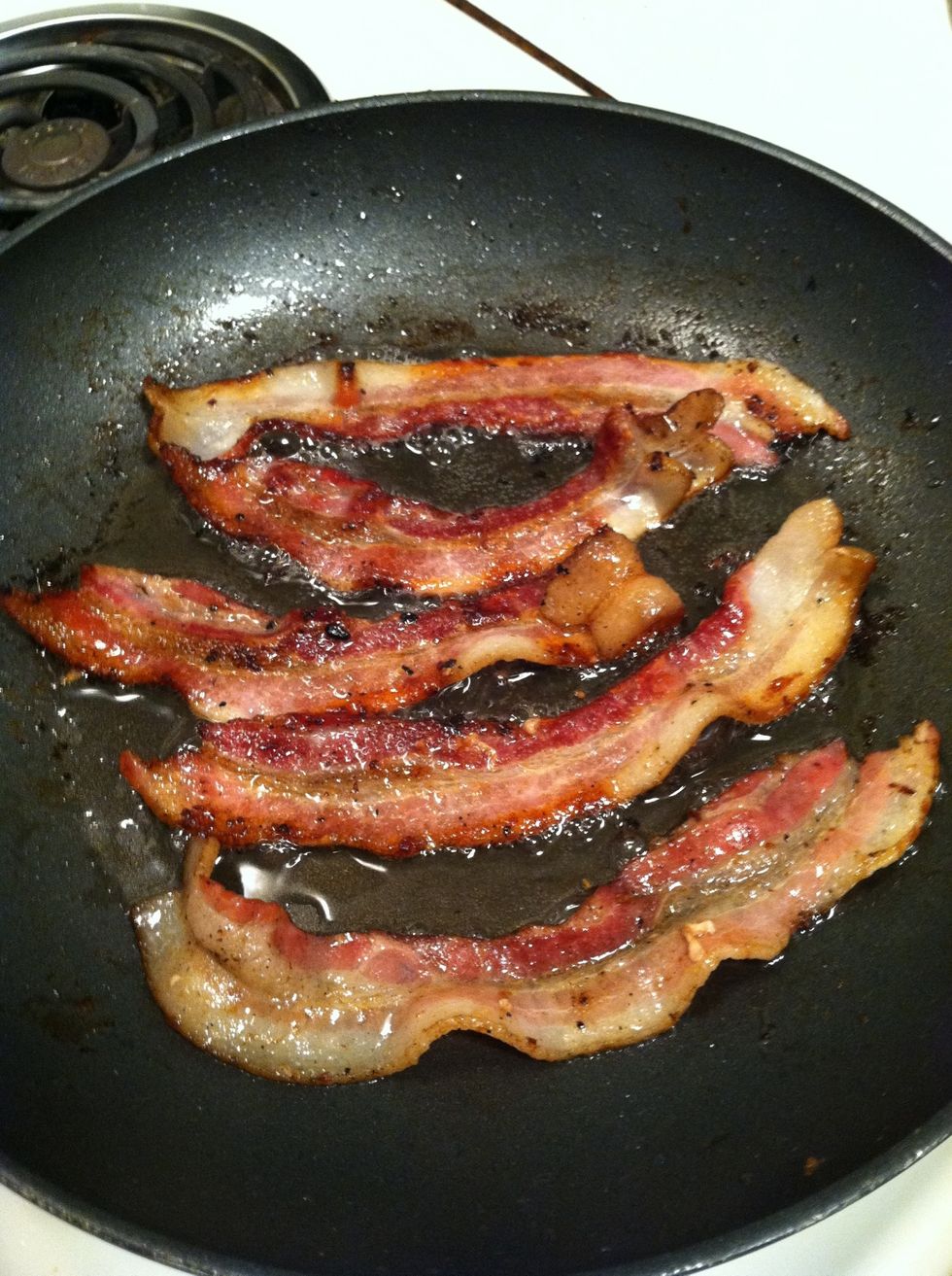 Now, flip the bacon again. This is what it should look like on the other side.  Note: One piece of bacon was sacrificed at this step to some beloved housepets.