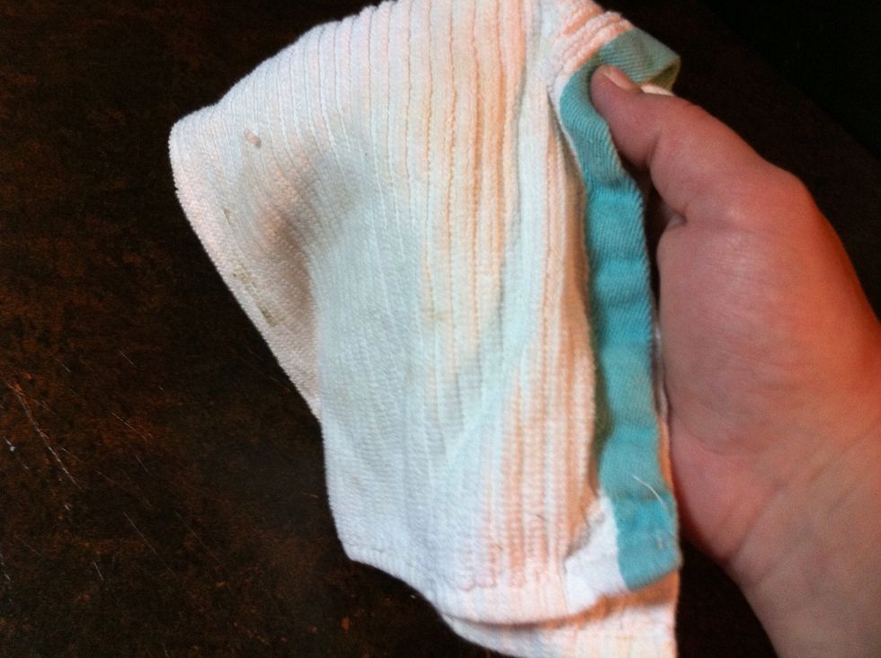 Now flip the towel and Buff it. To Buff it, you are just wiping off the excess so you can't feel the oil.