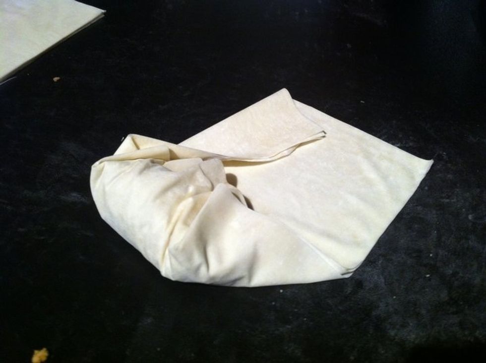 Now fold again with the new left and right corners your previous folded corners created. Only difference is now you'll be folding it more angular so the opposite end begins to appear more triangular.