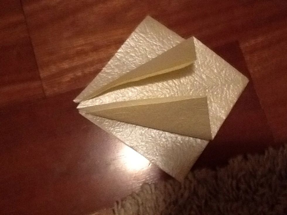 Now fold both flaps to the centre of the dimond. Flip and repeat on the other side