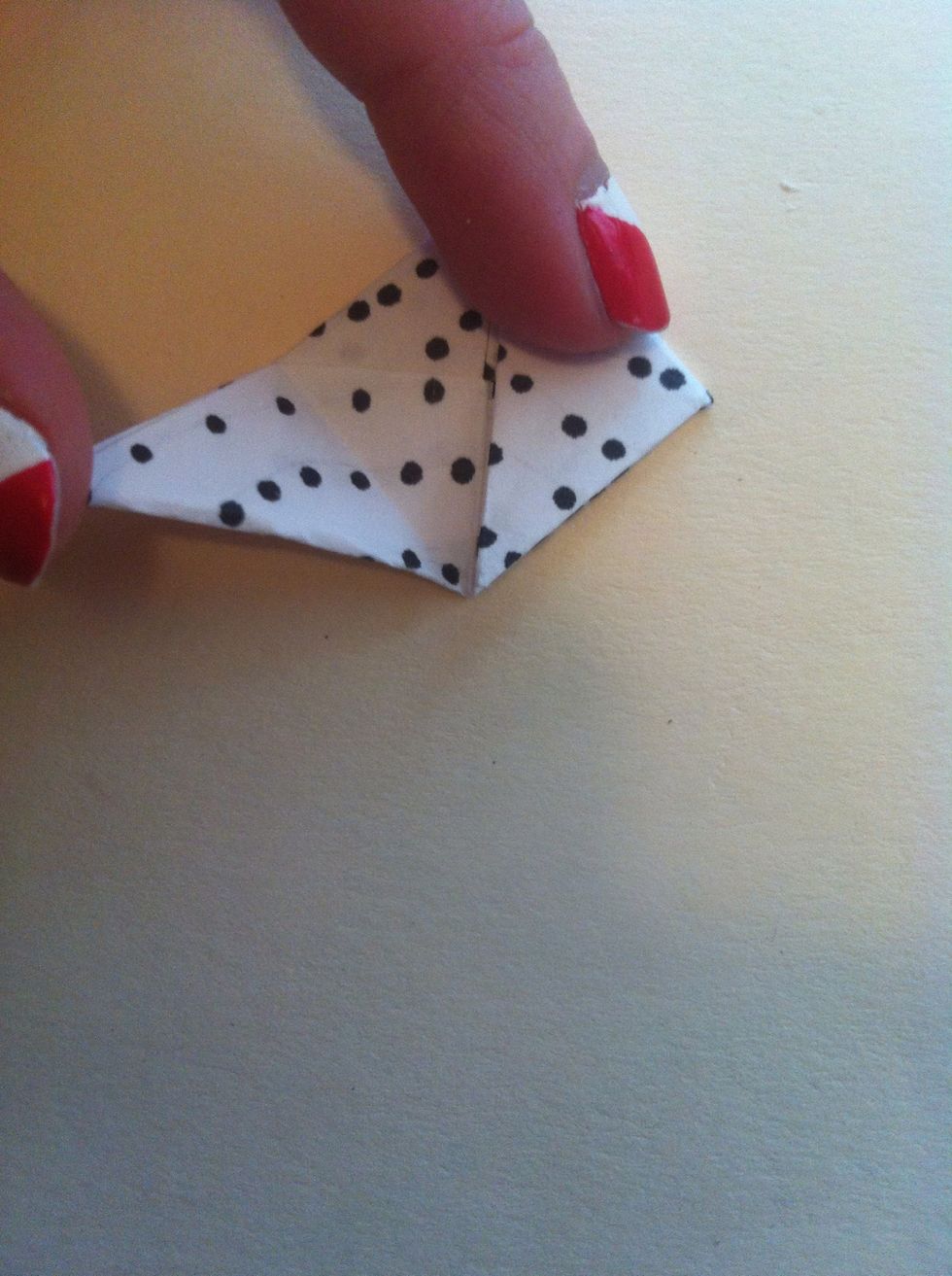 Now fold bottom left tip to top point.