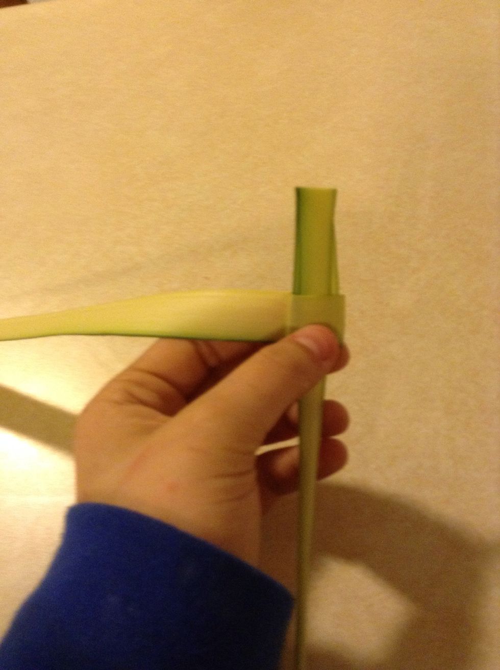 Now fold down the small top end and push it through the front fold. Leave it at the length you want the top of the cross to be.