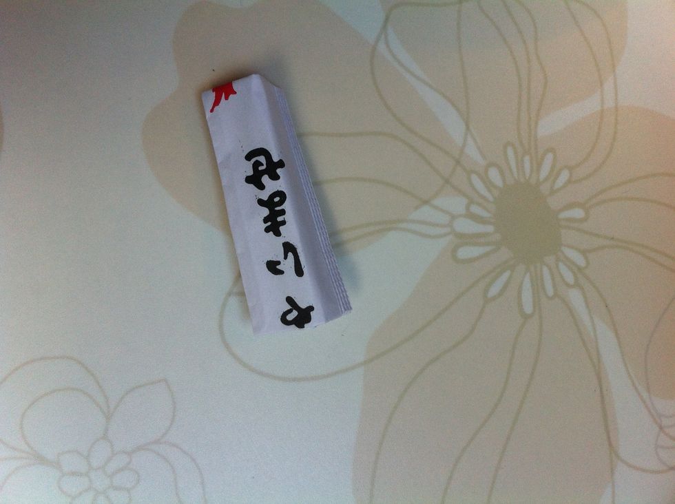 Now fold it in half in the opposite direction than before. You should now have a little triangle dome.